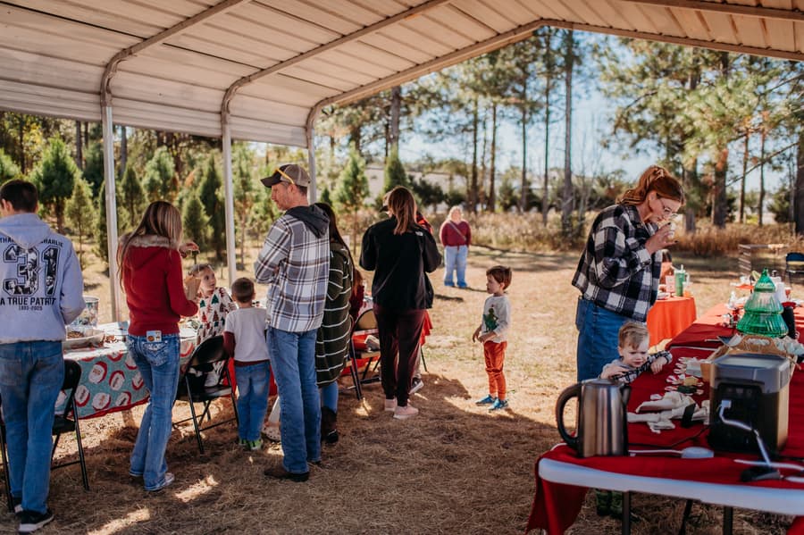 Families and kids gathered at festive tables under the covered tent